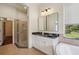Bathroom with a glass enclosed shower, marble countertop, and a neutral color palette at 19803 Prince Benjamin Dr, Lutz, FL 33549