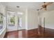 Bedroom with hardwood floors, ample natural light, and a door leading to the backyard and pool area at 19803 Prince Benjamin Dr, Lutz, FL 33549