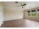 Bedroom featuring hardwood floors, ceiling fan, ample natural light from windows, and neutral wall color at 19803 Prince Benjamin Dr, Lutz, FL 33549