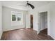 Bright bedroom with natural light, wood floors, and access to an ensuite bathroom at 19803 Prince Benjamin Dr, Lutz, FL 33549