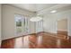 Bright dining area with hardwood flooring and a view of the outdoor landscape through large windows at 19803 Prince Benjamin Dr, Lutz, FL 33549
