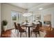 Staged dining room featuring modern lighting, hardwood floors, and neutral decor for elegant meals at 19803 Prince Benjamin Dr, Lutz, FL 33549