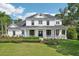 Stately two-story home showcasing a charming wrap-around porch and meticulous landscaping at 19803 Prince Benjamin Dr, Lutz, FL 33549