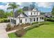 Stately two-story home featuring a three-car garage, well-manicured lawn and landscaping, and a welcoming front porch at 19803 Prince Benjamin Dr, Lutz, FL 33549