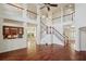 Spacious foyer with soaring ceilings, grand staircase, and hardwood floors for an inviting entrance at 19803 Prince Benjamin Dr, Lutz, FL 33549