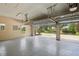 Spacious garage with epoxy flooring and an open garage door leading to the driveway at 19803 Prince Benjamin Dr, Lutz, FL 33549