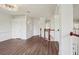 Bright hallway with laminate floors, white walls, crown molding, and stairs leading to the first floor at 19803 Prince Benjamin Dr, Lutz, FL 33549