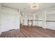 Well lit hallway with wood flooring, stairs and white trim at 19803 Prince Benjamin Dr, Lutz, FL 33549