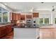 Gourmet kitchen featuring granite countertops, a stylish island, stainless steel appliances, and hardwood floors at 19803 Prince Benjamin Dr, Lutz, FL 33549