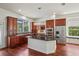 Gourmet kitchen featuring granite countertops, a stylish island, stainless steel appliances, and hardwood floors at 19803 Prince Benjamin Dr, Lutz, FL 33549