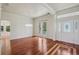 Spacious living room boasts hardwood floors, a modern light fixture, and a grand front door entrance at 19803 Prince Benjamin Dr, Lutz, FL 33549