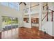 Bright, open living room features hardwood floors, soaring ceilings, and views of the pool at 19803 Prince Benjamin Dr, Lutz, FL 33549