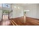 Bright and airy living room featuring high ceilings, hardwood floors, and an open staircase at 19803 Prince Benjamin Dr, Lutz, FL 33549