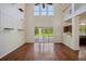 Open living room with high ceilings, wood floors and view of the outdoor pool and patio at 19803 Prince Benjamin Dr, Lutz, FL 33549