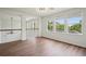 Bright living room with laminate floors, white walls, and railings overlooking the first floor at 19803 Prince Benjamin Dr, Lutz, FL 33549