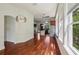 Open concept living room and kitchen area featuring hardwood floors and natural light at 19803 Prince Benjamin Dr, Lutz, FL 33549