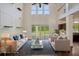 Staged living room with high ceilings, comfortable seating, and a view of the pool area at 19803 Prince Benjamin Dr, Lutz, FL 33549