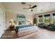 Well-lit bedroom featuring a ceiling fan, neutral walls, and stylish furniture at 19803 Prince Benjamin Dr, Lutz, FL 33549