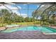 Screened-in pool and spa with brick-paver trim and golf course views that provides a private outdoor oasis at 19803 Prince Benjamin Dr, Lutz, FL 33549