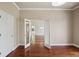 Neutral room featuring wood floors and a view into the next room through glass doors at 19803 Prince Benjamin Dr, Lutz, FL 33549