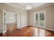 Open room with hardwood floors, French doors leading to balcony and neutral walls at 19803 Prince Benjamin Dr, Lutz, FL 33549