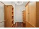 Walk-in closet with custom wood shelving, ample storage, and laminate wood flooring at 19803 Prince Benjamin Dr, Lutz, FL 33549