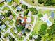 Aerial view showcases a residential neighborhood with tree-lined streets and community pool at 2212 Portside Psge, Palm Harbor, FL 34685