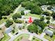 Aerial view of property, showcasing the lush landscaping and community amenities like the pool and tennis courts at 2212 Portside Psge, Palm Harbor, FL 34685