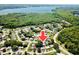 Aerial view of the property, highlighting its location within a neighborhood near lush green spaces and a lake at 2212 Portside Psge, Palm Harbor, FL 34685