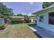 Beautiful backyard featuring flowering bushes, fence, and partial home view at 2212 Portside Psge, Palm Harbor, FL 34685