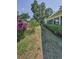 Landscaped backyard featuring lush greenery and mature trees at 2212 Portside Psge, Palm Harbor, FL 34685