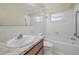 Bathroom features a white sink, white toilet, and a shower/tub combo at 2212 Portside Psge, Palm Harbor, FL 34685