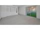 Spacious carpeted bedroom featuring a mirrored closet and access to a sunroom at 2212 Portside Psge, Palm Harbor, FL 34685