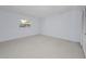 Bright bedroom with neutral carpet, closet and window at 2212 Portside Psge, Palm Harbor, FL 34685