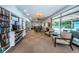Relaxing community room with book shelves, a dining area, and views overlooking the pool at 2212 Portside Psge, Palm Harbor, FL 34685