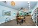 Well-appointed community room featuring a game table, book shelves, lounge seating and a pool table in the distance at 2212 Portside Psge, Palm Harbor, FL 34685