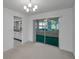 Open dining room area with a decorative chandelier and sliding glass doors leading to the patio at 2212 Portside Psge, Palm Harbor, FL 34685