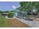 Exterior of a one story home featuring an attached garage and nice landscaping at 2212 Portside Psge, Palm Harbor, FL 34685