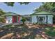 Charming single-story home featuring a brick facade and lush landscaping, creating a welcoming curb appeal at 2212 Portside Psge, Palm Harbor, FL 34685
