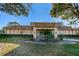 Building exterior featuring a covered entrance, well-kept landscaping, and mature trees at 2212 Portside Psge, Palm Harbor, FL 34685