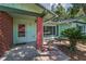 Charming home exterior featuring a brick accent wall, tiled front entrance, and a well-maintained lawn at 2212 Portside Psge, Palm Harbor, FL 34685