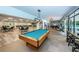 Expansive game room featuring pool table, dining tables, library and multiple lounge areas for community enjoyment at 2212 Portside Psge, Palm Harbor, FL 34685