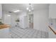 Open kitchen with white appliances, tiled floor and lots of cabinet space at 2212 Portside Psge, Palm Harbor, FL 34685
