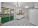 Kitchenette with white appliances, tiled floor and access to outdoor space at 2212 Portside Psge, Palm Harbor, FL 34685