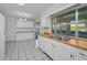 Spacious kitchen has stainless steel sink, tile floors and white cabinets at 2212 Portside Psge, Palm Harbor, FL 34685