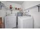 Functional laundry room featuring a washer, dryer, and water heater at 2212 Portside Psge, Palm Harbor, FL 34685