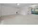 Large living room featuring neutral carpet and transitions into a tiled space and screened-in patio at 2212 Portside Psge, Palm Harbor, FL 34685