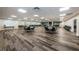 Spacious meeting room with wood-look floors, fireplace, and ample seating provides a community gathering space at 2212 Portside Psge, Palm Harbor, FL 34685