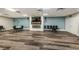 Large meeting room highlighting a decorative fireplace, flat screen TV, and neutral color scheme at 2212 Portside Psge, Palm Harbor, FL 34685