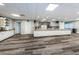 Meeting room featuring breakfast bar with modern appliances, long wood-look floors, and versatile seating at 2212 Portside Psge, Palm Harbor, FL 34685
